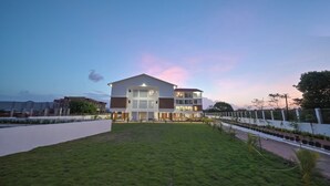 A modern two-story building with a flat roof and large windows. -  Ovi Resort and Spa (Mawal)