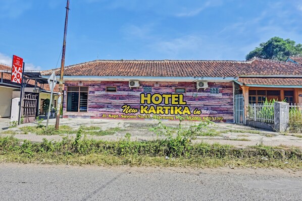Hotel 'Hotel Kartika' con fachada colorida, ubicado en Jl. Kapt. Suwono No.93, Majengan Ten., 0280 6265189.