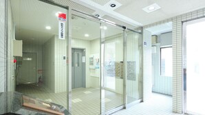 A modern interior with glass doors, tiled walls, and a marble counter.