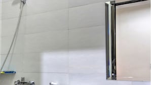 A bathroom with a toilet, a sink, and a shower. - OYO 3346 Rukos Colombus G5 (Karawang)