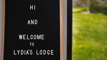 A sign with the text 'HI AND WELCOME TO LYDIA'S LODGE'.