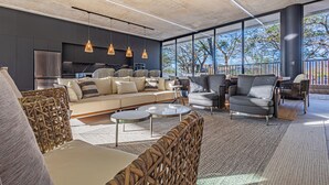 A modern living room with a sofa, chairs, and a dining area. - Casa Uana, luxury new home in gated community, private pool, steps to the beach (Tamarindo)