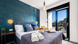 A modern bedroom with a large bed, a bedside table, a nightstand, and a view of the outside. - Luxurious home in Zadar (Zadar)