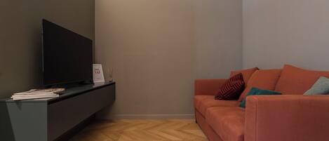 City Apartment | Living area | 35-inch flat-screen TV with digital channels