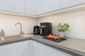Fridge, stovetop, dishwasher, coffee/tea maker