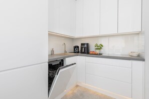 Fridge, stovetop, dishwasher, coffee/tea maker