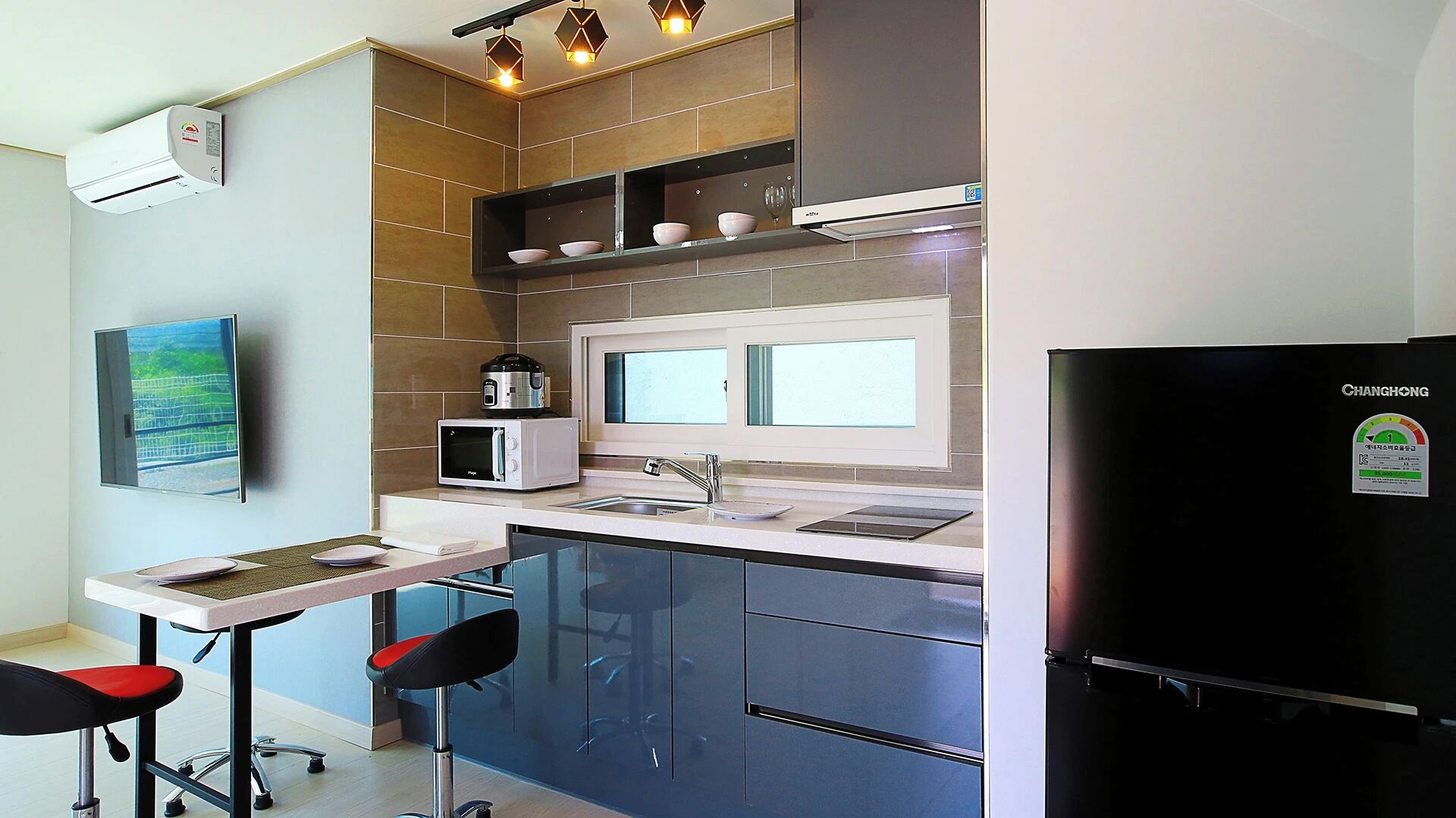 A modern kitchen with a built-in microwave, a stove, and a refrigerator.