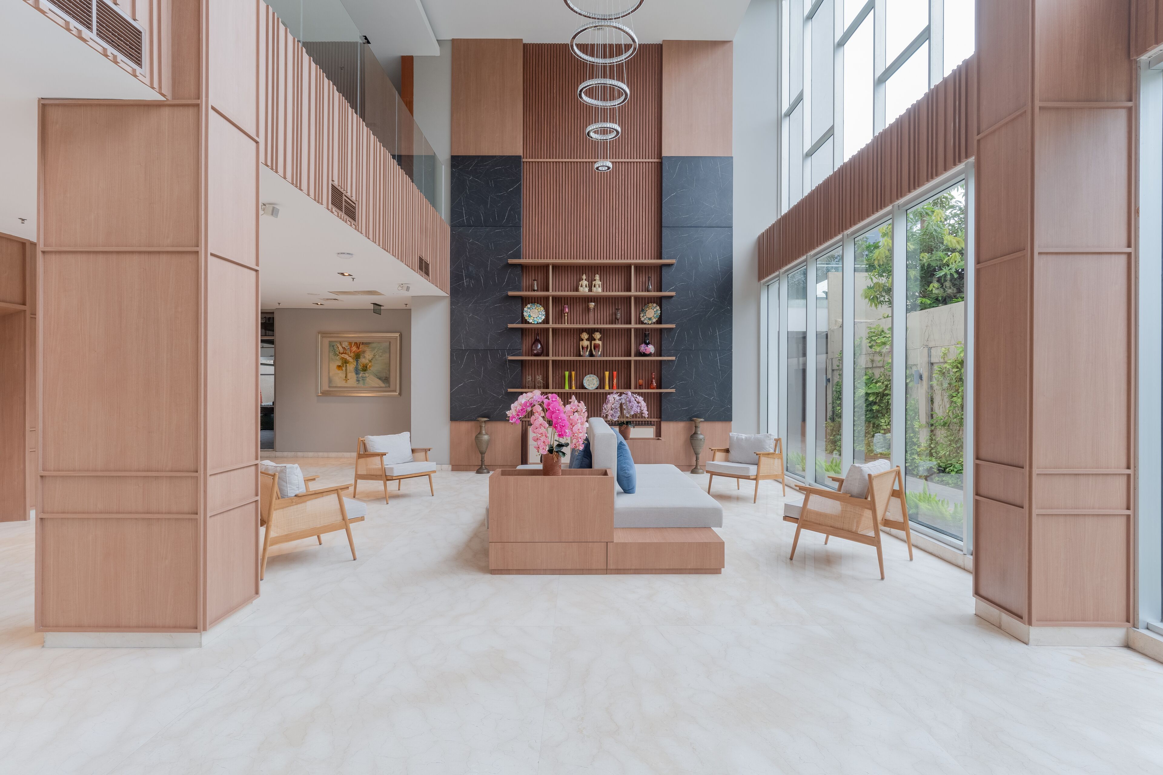 A spacious lobby with a central seating area, a high ceiling, and a modern design.