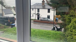 A residential street with houses, parked cars, and a motorcycle. - Great 5-bed Wembley Home 25min From Central London (Harrow)