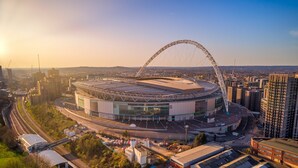 A stadium with a large arch structure, surrounded by urban buildings and roads. - Great 5-bed Wembley Home 25min From Central London (Harrow)