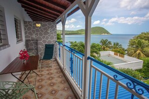 Enjoy breathtaking views of the water and distant island from this balcony.