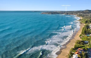 An aerial view of a coastal area with a beach, houses, and a lighthouse labeled "Cooff's Harbour". - Stunning 6-bedroom, 3-bathroom home. Exclusive, absolute beachfront location (Sapphire Beach)