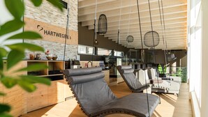 Un interior moderno con techo de madera, lámparas colgantes y una zona de cocina.