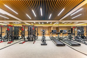 A modern gym with various exercise equipment, including treadmills, weight machines, and free weights. - Holiday Inn Express Suzhou Bay (Suzhou)