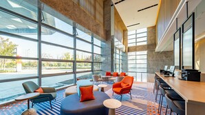 A spacious lobby with large windows, a seating area with various chairs and tables, and a reception desk. - Holiday Inn Express Suzhou Bay (Suzhou)
