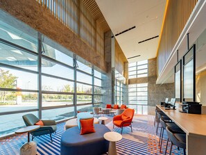 A spacious lobby with large windows, a seating area with various chairs and tables, and a reception desk. - Holiday Inn Express Suzhou Bay (Suzhou)
