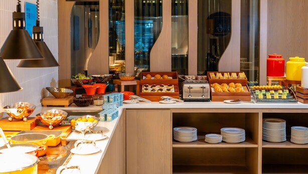 A breakfast buffet with various food items and utensils. - Holiday Inn Express Suzhou Bay (Suzhou)