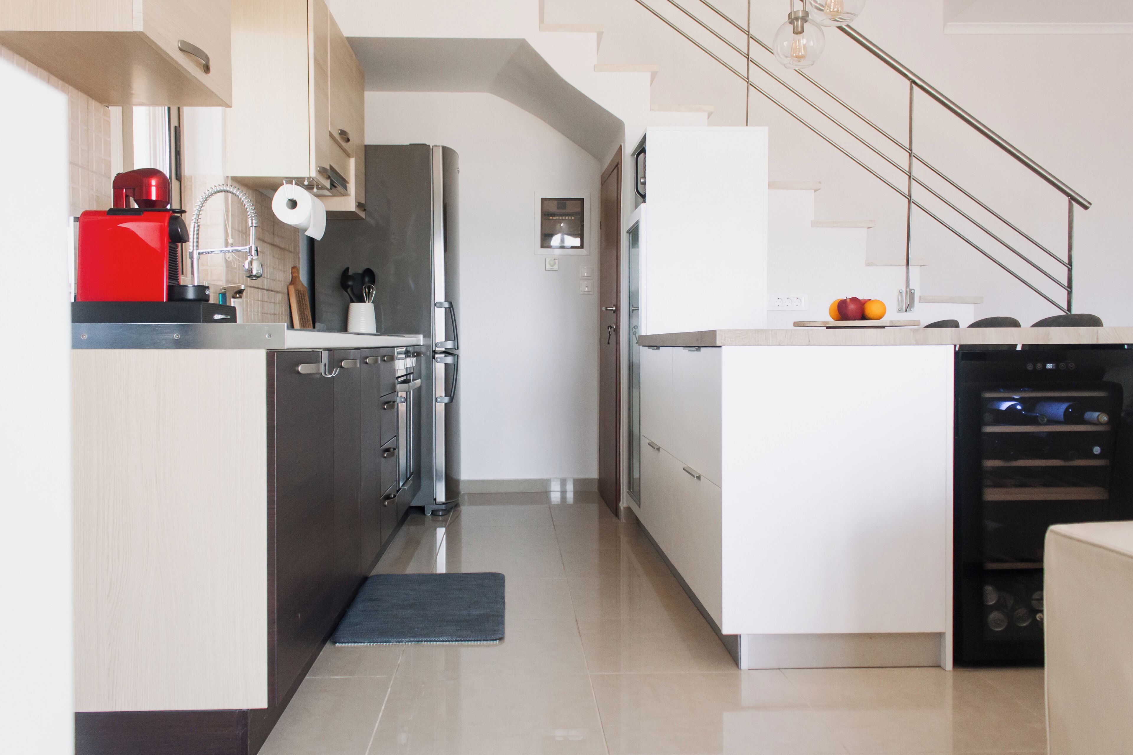 A modern kitchen with stainless steel appliances, a wooden countertop, and a built-in dishwasher.