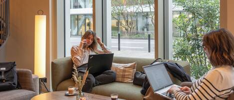 A modern interior with a sofa, a coffee table, and a laptop.