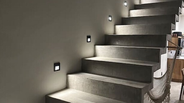 A modern staircase with built-in lighting, leading to a landing area with a hammock and a wooden bench. - Quiet La Punta Surf Villa (Santa María Colotepec)