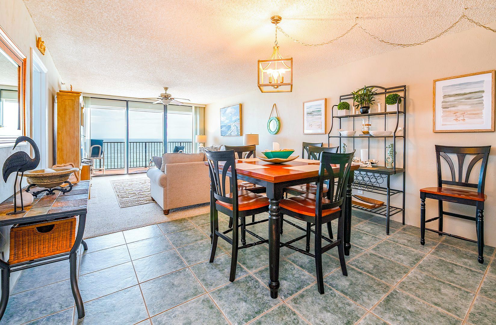 A dining area with a table, chairs, and a view to the outside.