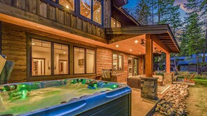 A wooden cabin with a hot tub, outdoor seating, and a stone fireplace. - Family Time Comes First | Stay Longer w/ 1PM In/Out Benefits (Cle Elum)