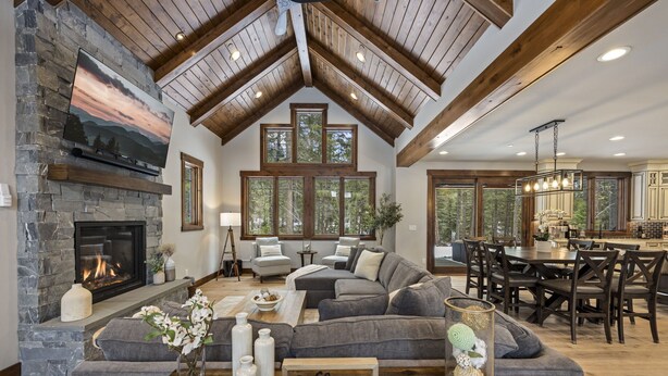 A spacious living room with a stone fireplace, large windows, and a cozy seating area. - Family Time Comes First | Stay Longer w/ 1PM In/Out Benefits (Cle Elum)