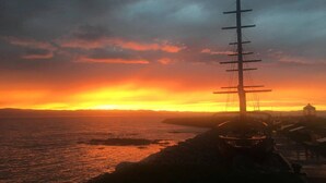 A coastal sunset with a prominent utility pole and a small building in the foreground. - Distinctive 5-room inn, located a few steps from the river to discover the multi (SAINT JEAN PORT JOLI)