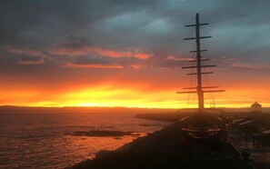 A coastal sunset with a prominent utility pole and a small building in the foreground. - Distinctive 5-room inn, located a few steps from the river to discover the multi (SAINT JEAN PORT JOLI)