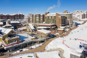 A ski resort with multiple buildings, including a hotel with a ski lift and a ski slope.