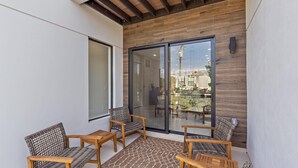 A balcony with wooden chairs and a glass door leading to an outdoor area. - Uptown Luxury On Audubon 4 Bedroom Townhouse by RedAwning (Sarasota)