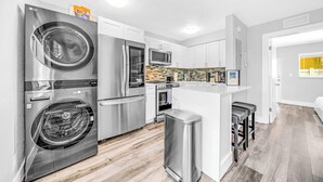 A modern kitchen with stainless steel appliances, a built-in oven, and a microwave. - Victoria Park Getaway! 1 Mile to Beach & Las Olas! (Fort Lauderdale)