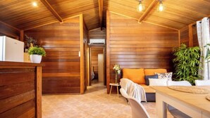 Un interior de madera con un sofá, una mesa de comedor y sillas.