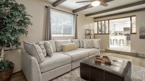 A living room with a sectional sofa, a coffee table, a large plant, and a ceiling fan. - Large home inArvada, centrally located, 20min to downtown, garage parking, 420ok (Arvada)