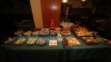A buffet table with various food items and condiments.
