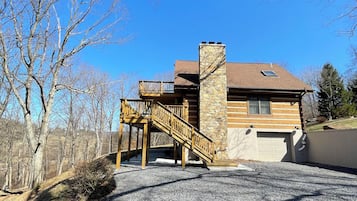 Escape to a cozy retreat surrounded by nature, with a balcony offering a view of the forest.