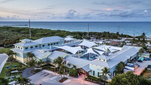 A resort with multiple buildings, a swimming pool, and a view of the ocean. - ON The Beach Juno! 4-Steps to the Beach! (Juno Beach)
