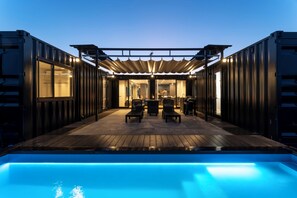 A poolside area with a pergola, seating, and a view into the interior. - RIVIERA Kujukuri (Kujukuri)