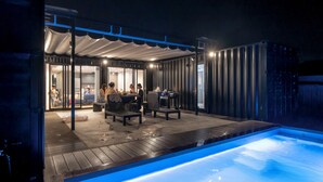 An outdoor pool area with a covered seating area and a pool. - RIVIERA Kujukuri (Kujukuri)