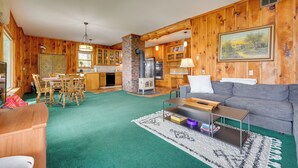 A wooden interior with a dining area, kitchen, and living room. - 1902 Family Lakehouse: Screened Porch & Views (Queensbury)