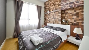 A neatly made bed with a patterned bedspread, a bedside table with a lamp, and a wall-mounted shelf with decorative items. - Wonderful 2 bedrooms condo in T1 Masteri Thao Dien (Ho Chi Minh City)