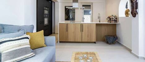 A modern apartment with a living room, kitchenette, and a dining area.