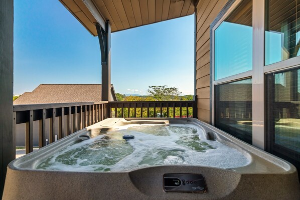A hot tub on a balcony with a clear view of the surrounding area.