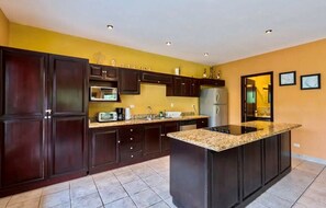 Een koelkast, een magnetron, kookgerei, borden en bestek