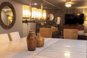 Un espace repas comprenant une table, des chaises et des vases décoratifs.