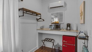 A compact kitchenette with a microwave, coffee maker, and a red refrigerator. - Little Inn on Main 214 West Main Street (Washington)