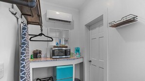 A compact kitchen with a microwave, coffee maker, and a small fridge. - Little Inn on Main 214 West Main Street (Washington)