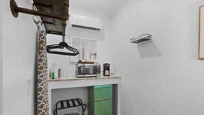 A compact kitchen with a microwave, coffee maker, and a green refrigerator. - Little Inn on Main 214 West Main Street (Washington)
