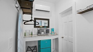A compact kitchen with a microwave, coffee maker, and a small fridge. - Little Inn on Main 214 West Main Street (Washington)
