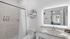 A modern bathroom with a shower, toilet, and sink. - Little Inn on Main 214 West Main Street (Washington)